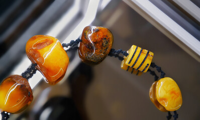 Amber  beads on the glass shelf.