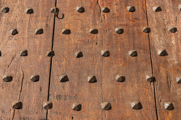 Very old wooden gates with studded metal studs