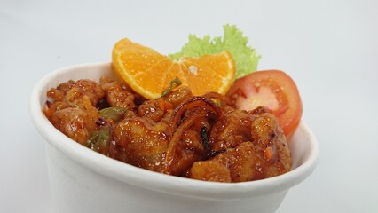 close up of orange chicken on the paper bowl - isolated on white background.