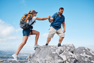 Helping hand, couple climbing or hiking mountain in nature on vacation, holiday or trip. Freedom,...