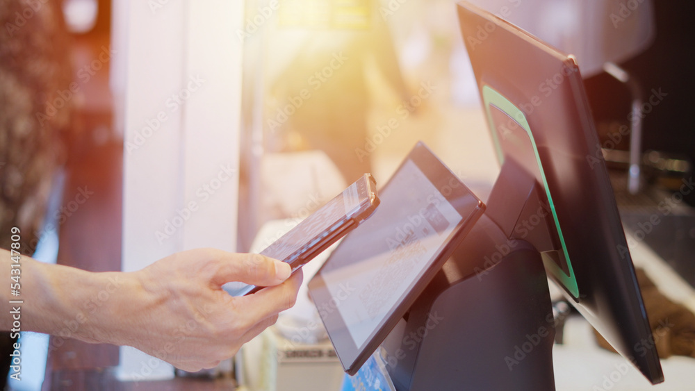 Poster close up man uses mobile phone to scan qr code for payment