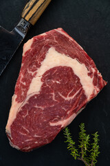 Wagyu Beef Ribeye Steak Raw Dry Aged on Black Background