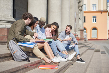 group of students communicates sitting on the steps