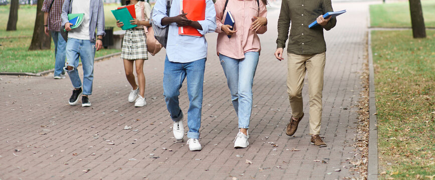 group of students walking through the park after lectures.