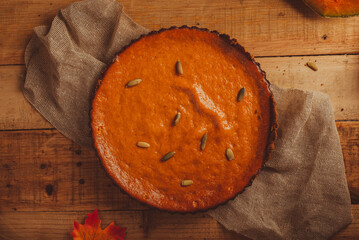 Pumpkin pie on wooden table. Dessert for thanksgiving dinner and pumpkin on wooden table.