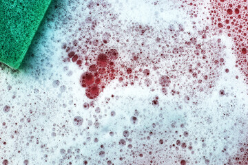 soap foam and sponge on a pink background