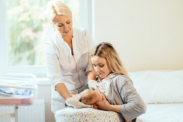 Lactation consultant. Breastfeeding Support and Help for nursing mother. Mother feeding with breast...