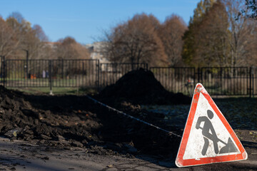 warning sign indicating earthworks on the street