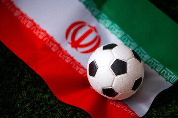 Iran national football team. National Flag on green grass and soccer ball. Football wallpaper for Championship and Tournament in 2022. World international match.