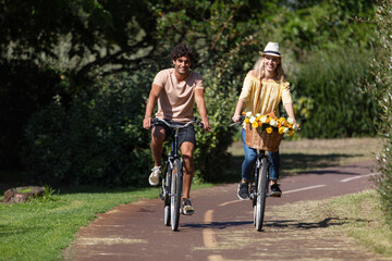 young smiling couple riding bicycles