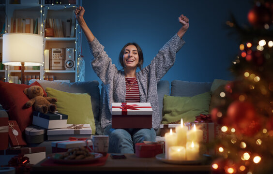 Cheerful Woman Opening Christmas Gifts