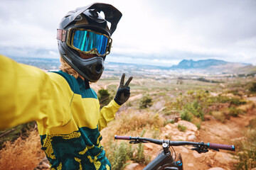 Cycling fitness, selfie and hand, peace and sign by cyclist riding along mountain, adventure and exercise. Nature, bike and picture by athletic man on solo journey, enjoy scenic view in South Africa