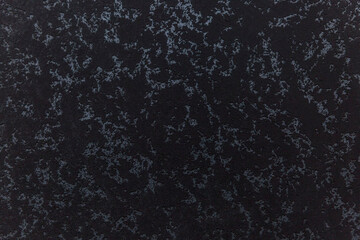 The surface of a black marble wall with gray veins. Modern materials in construction and interior design. Background. Space for text.