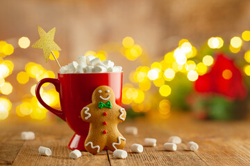 Christmas homemade gingerbread cookie and cup of hot chocolate with marshmallow on wooden table....
