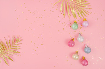 Pink Christmas background with balloons and golden branch with copy space