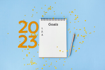 New Year goals List 2021 with notebook written in handwriting about plan listing of new year goals...