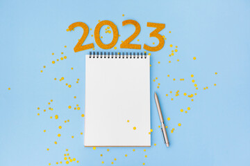 New Year empty goals, plans, resolutions 2023 concept with empty notebook and pen. flat lay style....