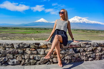 Young girl on the background of a beautiful view of mount Ararat in the afternoon. Armenia2019