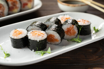 Maki rolls with salmon and cheese on white plate. Sushi menu. Japanese food.