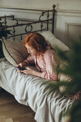 Atmospheric photo of a red-haired girl at home