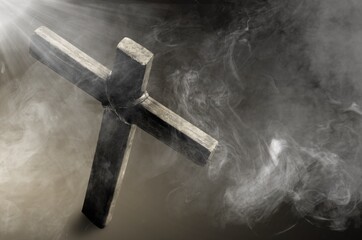 Christian wooden cross with white smoke