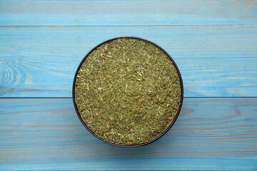 Obraz na płótnie Canvas Dried dill on turquoise wooden table, top view