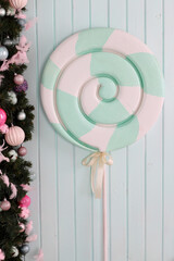 Colorful neo mint lollipop candy on pale background.