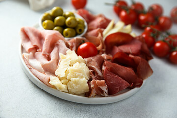 Homemade meat and cheese platter with green olives