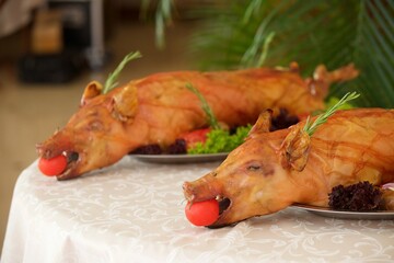 Baked piglets on the festive table. Meat dishes at the restaurant.