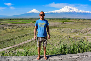 Young man on the background of a beautiful view of mount Ararat in the afternoon. May 6, 2020. Armenia.