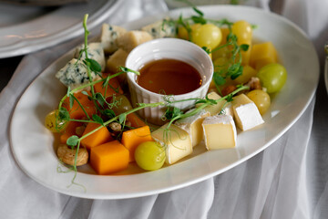 Cheese plate at the banquet, several types of cheeses and sauces
