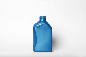 Motor oil in blue canister on light background