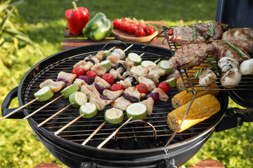 Cooking meat and vegetables on barbecue grill outdoors