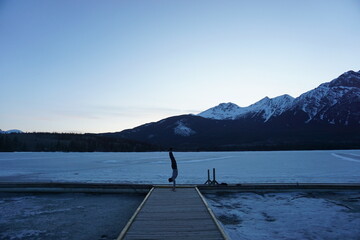 Man doing handstand with scenic mountain and lake