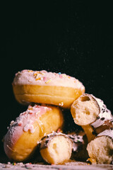 Donuts with chocolate glaze  with sugar powder on the dark background. Pastries concept.
