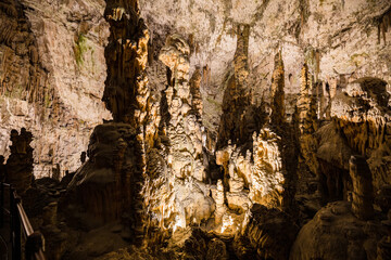 Under the ground. Beautiful view of stalactites and stalagmites in an underground cavern - Postojna cave, Slovenia, Europe