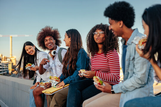 Stylish Students Bonding Over Lunch Outside.