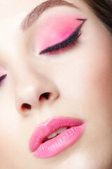 Obraz premium Closeup macro shot of human female face with pink makeup. Eyes closed.