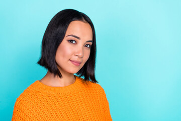 Fototapeta premium Portrait of positive girlish gorgeous woman with bob hairstyle wear orange sweater look at camera isolated on teal color background