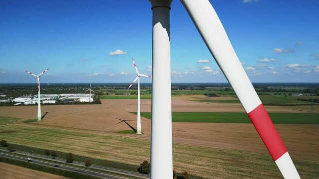Huge rotor blades of a Wind energy turbine. Gorgeous aerial view flight