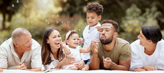 Happy, smile and big family blowing bubbles in a garden on a summer picnic in Puerto Rico. Happiness, grandparents and parents with children playing, having fun and relaxing together in the park