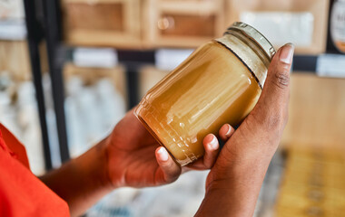 Shopping, peanut butter in hands and grocery store customer decision for sale product, discount or...