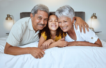 Love, bonding and mature people with child bonding while relaxing on the bed at home. Grandmother,...