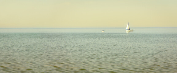 Sailboat on sea with clear sky, minimalist concept idea. High resolution photo image can be used as...