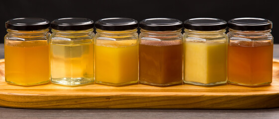Hexagonal jars with different types and colors of fresh flower honey. vitamin food for health and life