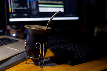 Mate drink at workplace in the evening. A calabash mate in the foreground. In the background...