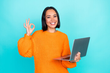 Photo of pretty cute girl dressed orange pullover showing okey chatting modern gadget isolated teal...