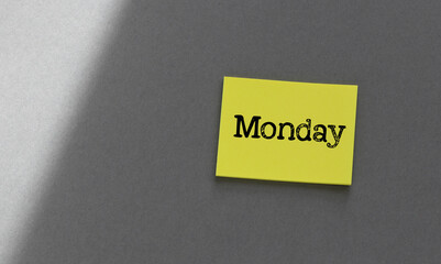 The word MONDAY on a yellow piece of paper.