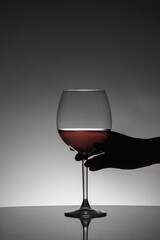 Female hand getting a red wine cup.