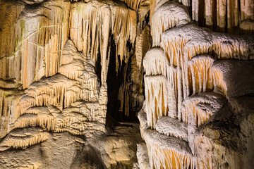 Under the ground. Beautiful view of stalactites and stalagmites in an underground cavern - Postojna cave, Slovenia, Europe